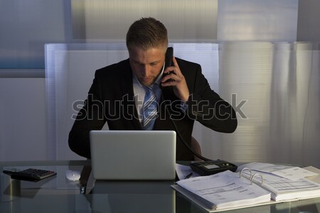 Stressed businessman working late into the night Stock photo © AndreyPopov