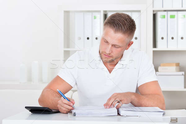 Businessman working at his desk in the office Stock photo © AndreyPopov