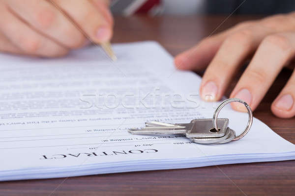 Man Signing Contract With Keys On It Stock photo © AndreyPopov