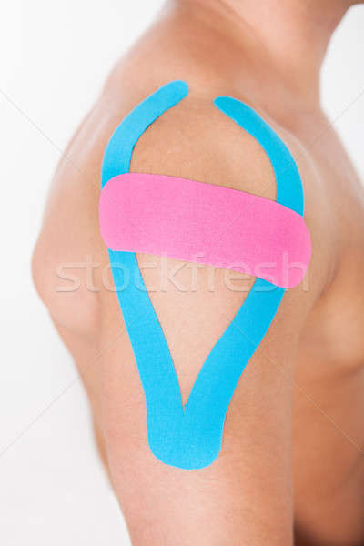 Young Man With Physio Tape Applied On Shoulder Stock photo © AndreyPopov