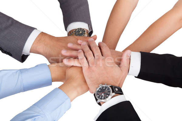 Businesspeople's Hands On Top Of Each Other Symbolizing Unity Stock photo © AndreyPopov