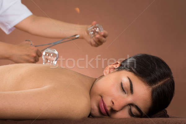 Person Holding Lit Camphor And Cup Stock photo © AndreyPopov