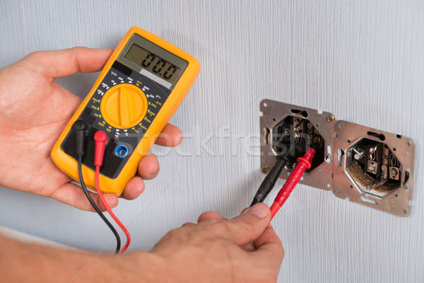 Person Hand Checking Socket Voltage Stock photo © AndreyPopov