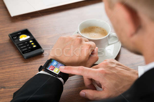 Businessman Checking Weather On Smartwatch Stock photo © AndreyPopov