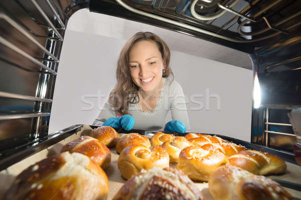 Woman Removing Bun View From Inside The Oven Stock photo © AndreyPopov