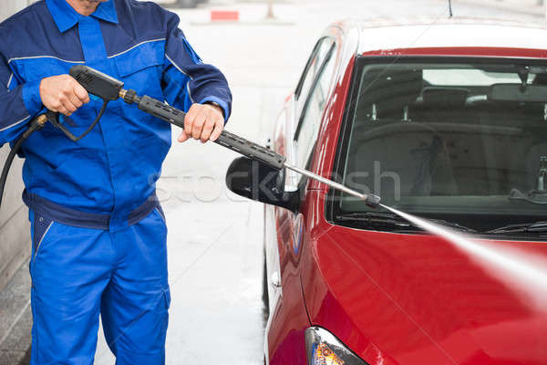 Worker Cleaning Car With Jet Sprayer At Service Station Stock photo © AndreyPopov