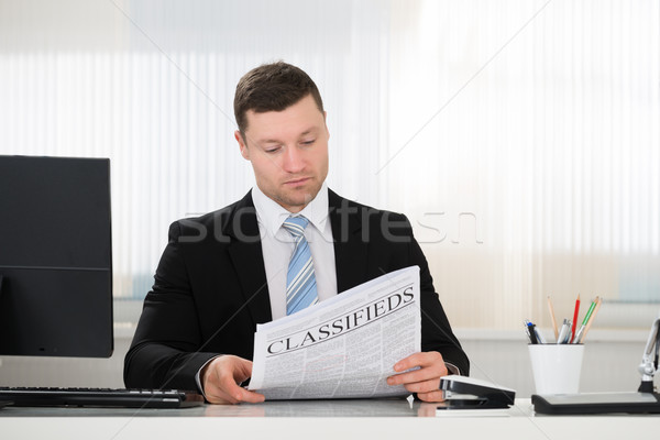Businessman Reading Newspaper In Office Stock photo © AndreyPopov