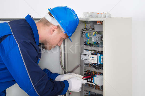 Male Technician Examining Fusebox Stock photo © AndreyPopov