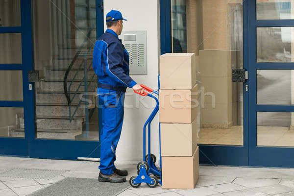Delivery Man With Trolley Using Security To Enter Building Stock photo © AndreyPopov