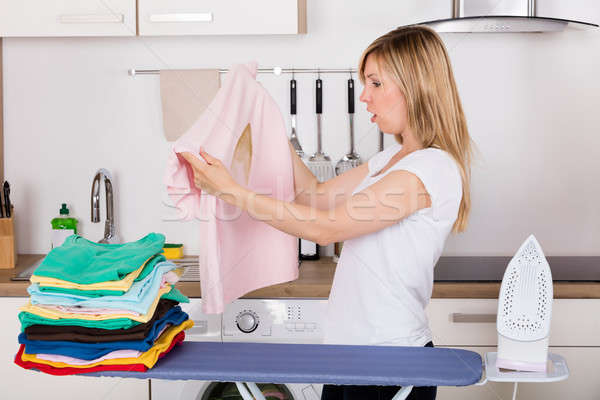 Shocked Woman Looking At Burnt T-shirt Stock photo © AndreyPopov