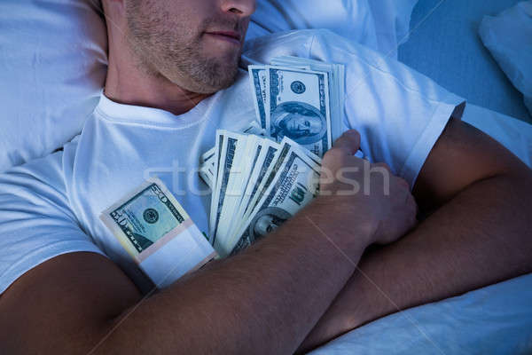 Człowiek snem waluta zauważa bed ceny Zdjęcia stock © AndreyPopov