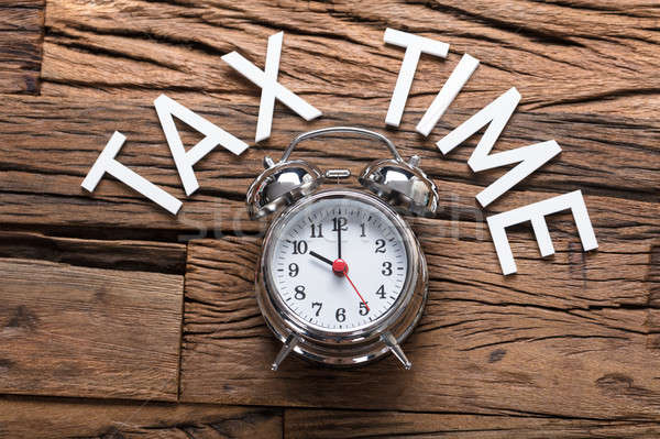 Tax Time Text By Alarm Clock On Wooden Table Stock photo © AndreyPopov