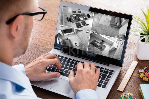 Man Monitoring The Video Footage On Laptop Stock photo © AndreyPopov