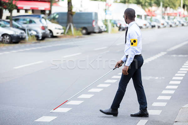 Blind Man Wearing Armband Walking With Stick Stock photo © AndreyPopov