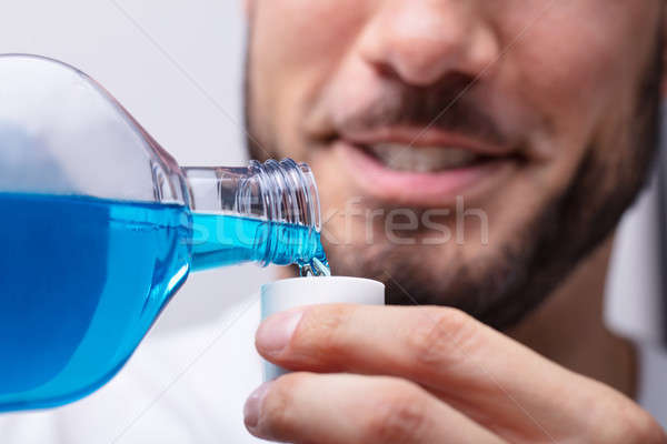 Man Pouring Mouthwash In To Cap Stock photo © AndreyPopov