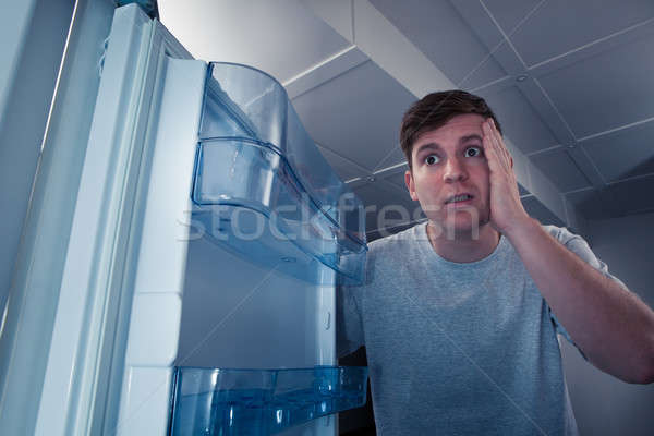 Hungry man looking in refrigerator Stock photo © AndreyPopov