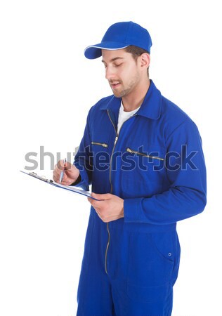 Mechanic In Overall Writing On Clipboard Stock photo © AndreyPopov