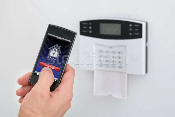 Security Alarm Keypad With Person Disarming The System Stock photo © AndreyPopov