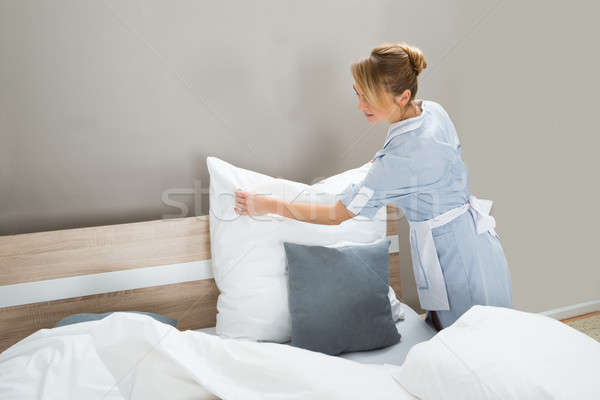 Housekeeping Worker Putting White Pillows Stock photo © AndreyPopov