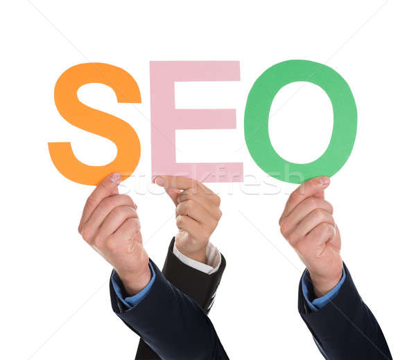 Multiple Hands Holding SEO Word Stock photo © AndreyPopov