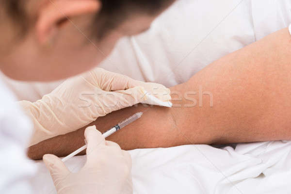 Doctor Injecting Vaccine To Patient Stock photo © AndreyPopov
