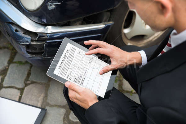 Man Holding Digital Tablet Examining Damaged Car Stock photo © AndreyPopov