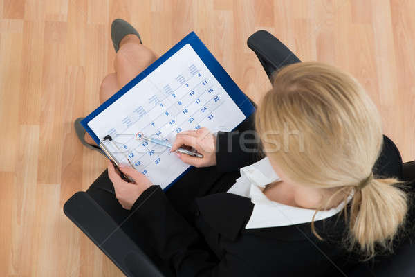 Businesswoman Marking Date On Calendar Stock photo © AndreyPopov