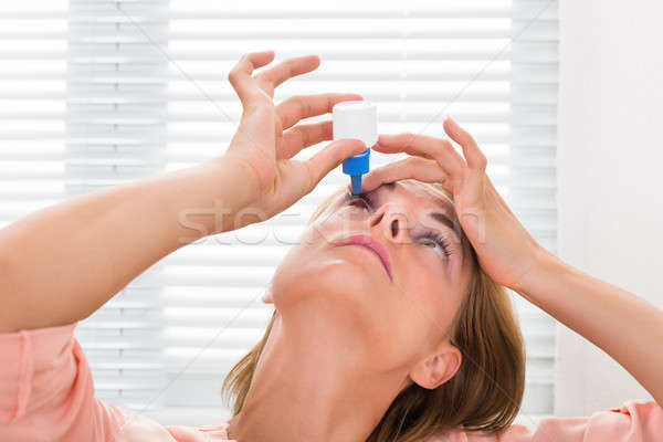 Nő áramló gyógyszer cseppek szemek közelkép Stock fotó © AndreyPopov