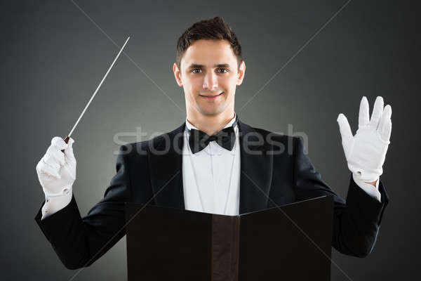 Smiling Music Conductor Holding Baton Stock photo © AndreyPopov