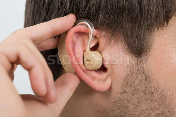 Man Wearing Hearing Aid In Ear Stock photo © AndreyPopov