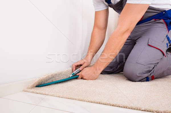 Person Cutting Carpet With Cutter Stock photo © AndreyPopov