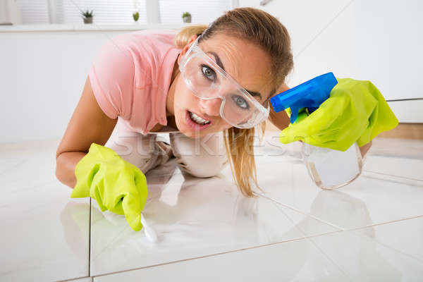 Frustrated Woman Cleaning Floor With Brush Stock photo © AndreyPopov