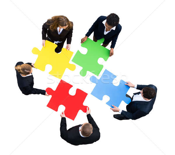 Businesspeople Solving Jigsaw Puzzle Stock photo © AndreyPopov