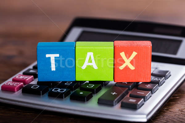 Blocks With Word Tax Placed Over Calculator Stock photo © AndreyPopov
