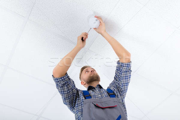 Male Electrician Fixing Smoke Detector Stock photo © AndreyPopov