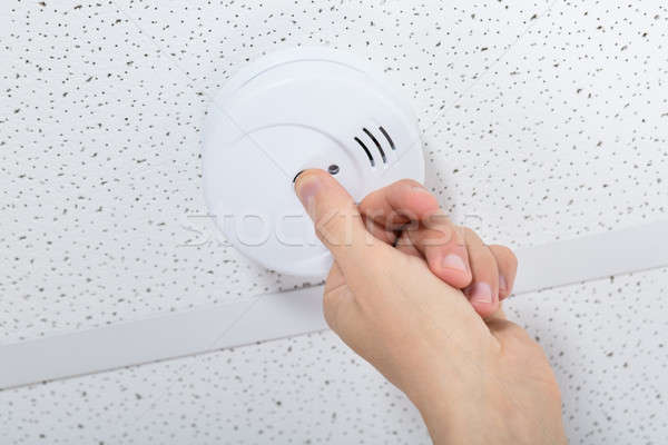 Person's Hand Installing Smoke Detector On Ceiling Stock photo © AndreyPopov