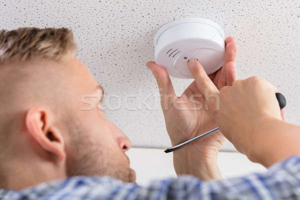Person's Hand Installing Smoke Detector On Ceiling Stock photo © AndreyPopov
