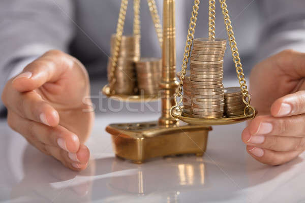 Businessperson Protecting Justice Scale With Stacked Of Coins Stock photo © AndreyPopov