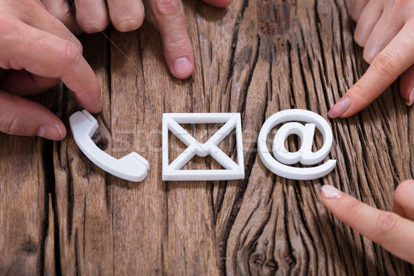 Stock photo: Hands Assembling Contact Us Icons