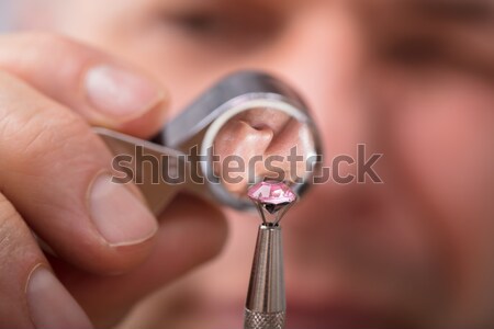 Jeweler Examining Diamond Through Loupe Stock photo © AndreyPopov
