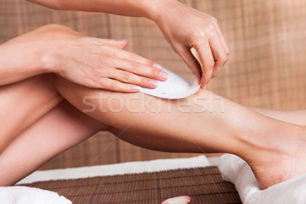 Young woman doing depilation on legs Stock photo © AndreyPopov