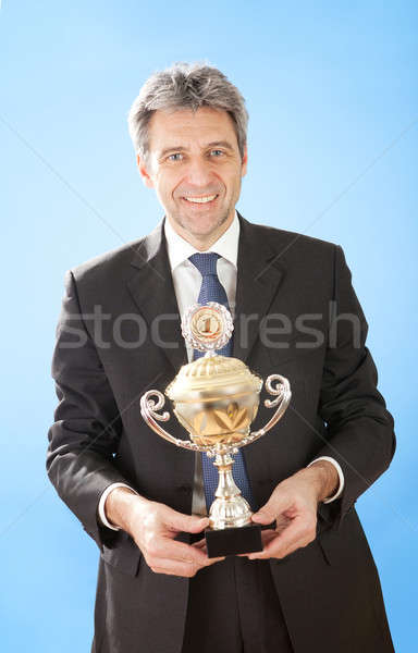 Stock photo: Senior businessmen holding a trophy