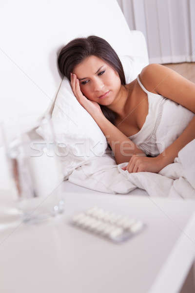 Sick woman resting in bed Stock photo © AndreyPopov