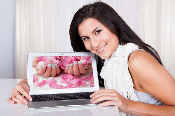 Happy woman looking for fingernail designs Stock photo © AndreyPopov