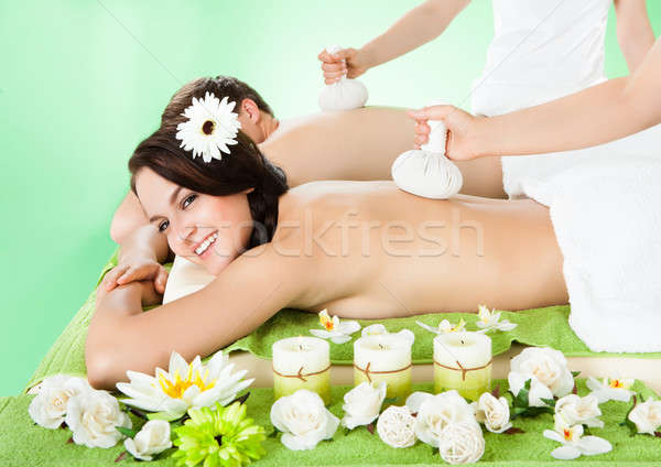 Couple Receiving Massage With Herbal Compress Balls Stock photo © AndreyPopov