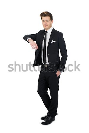 Confident Businessman Leaning On Invisible Wall Stock photo © AndreyPopov