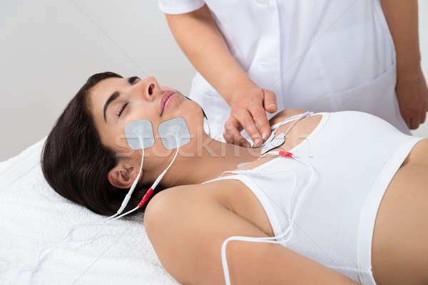 Woman Lying With Electrodes On Chest And Face Stock photo © AndreyPopov