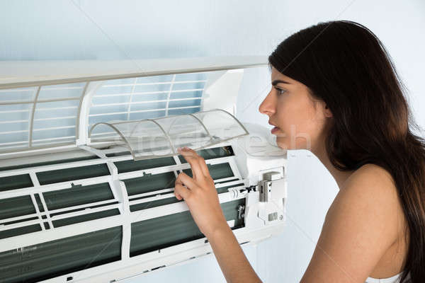 Woman Checking Air Conditioner Stock photo © AndreyPopov