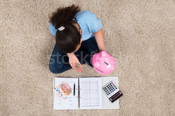 Woman Inserting Coin In Piggybank Stock photo © AndreyPopov