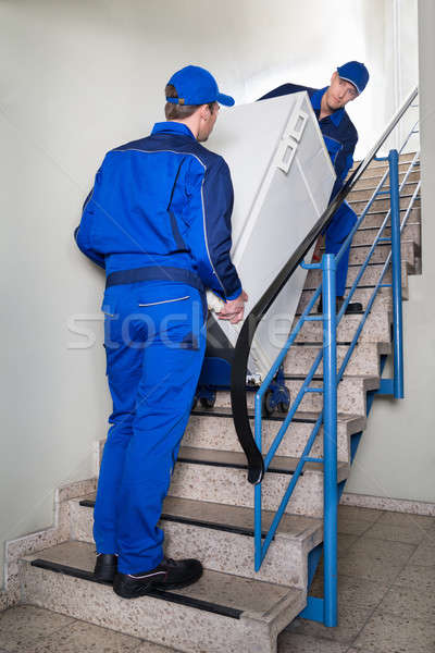 Movers Carrying Refrigerator On Steps Stock photo © AndreyPopov